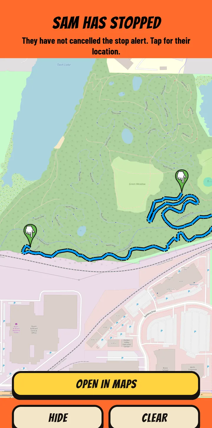 The orange alert a partner sees when a rider has stopped, with the rider's spot and the trail route on the map